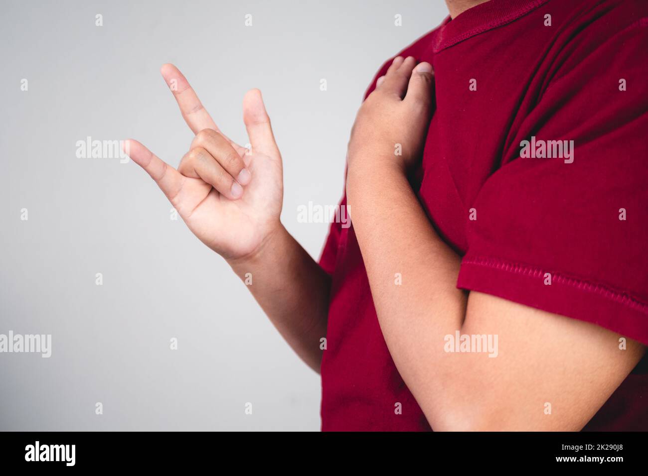 Sign of self love. Hug youself and Positive thinking. The man with red shirt in medium close up shot. Copy space for messages, words and texts. Stock Photo