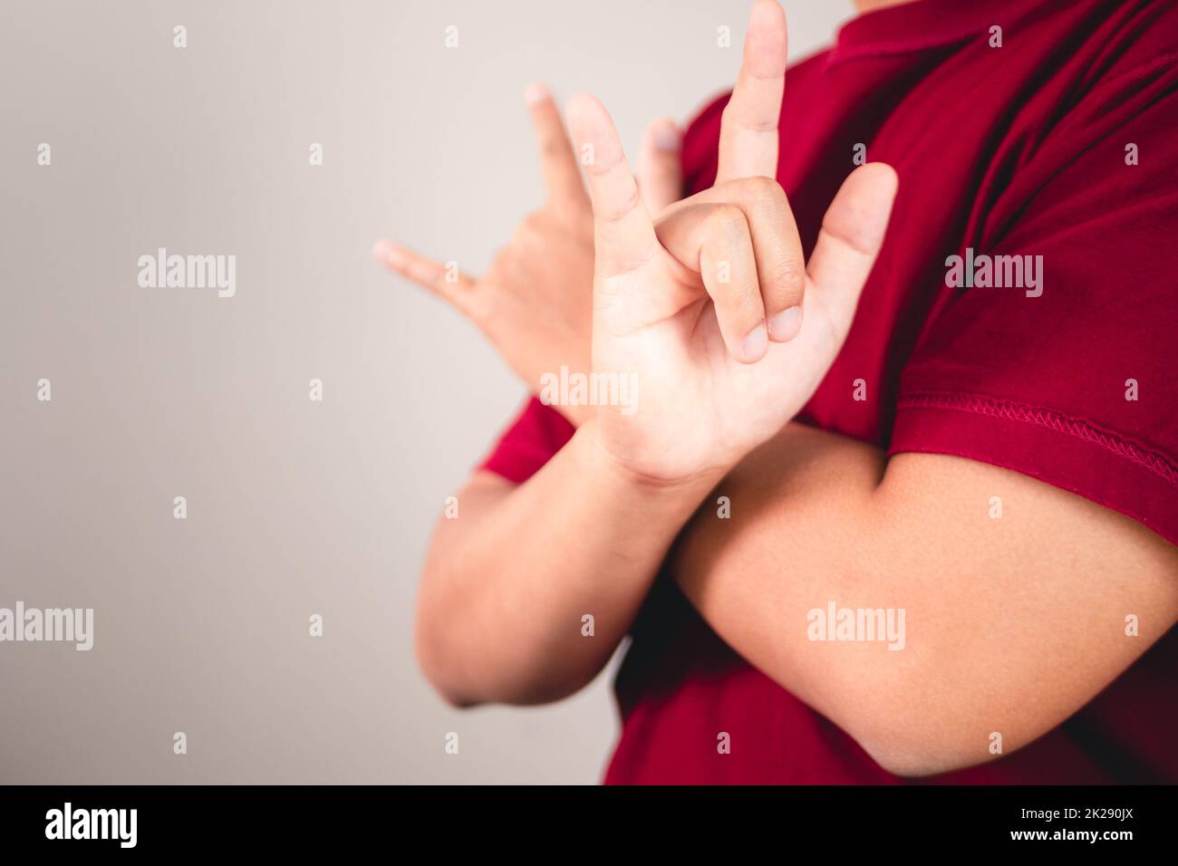 Sign of self love. Hug youself and Positive thinking. The man with red shirt in medium close up shot. Copy space for messages, words and texts. Stock Photo