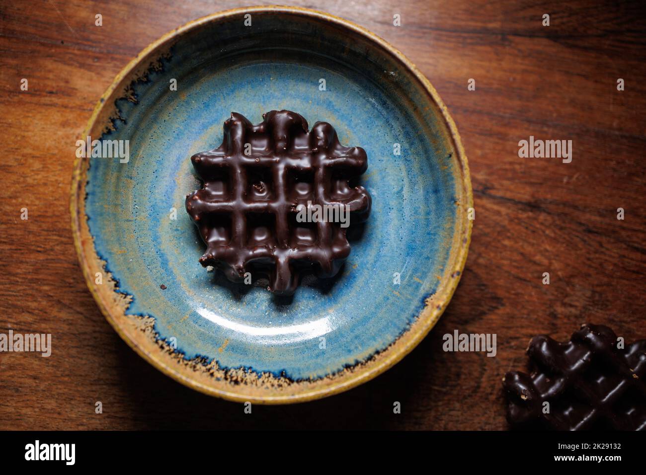 Chocolate waffle in handmade clay plate Stock Photo