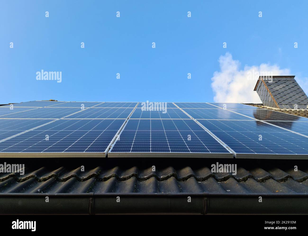 Solar panels producing clean energy on a roof of a residential house ...