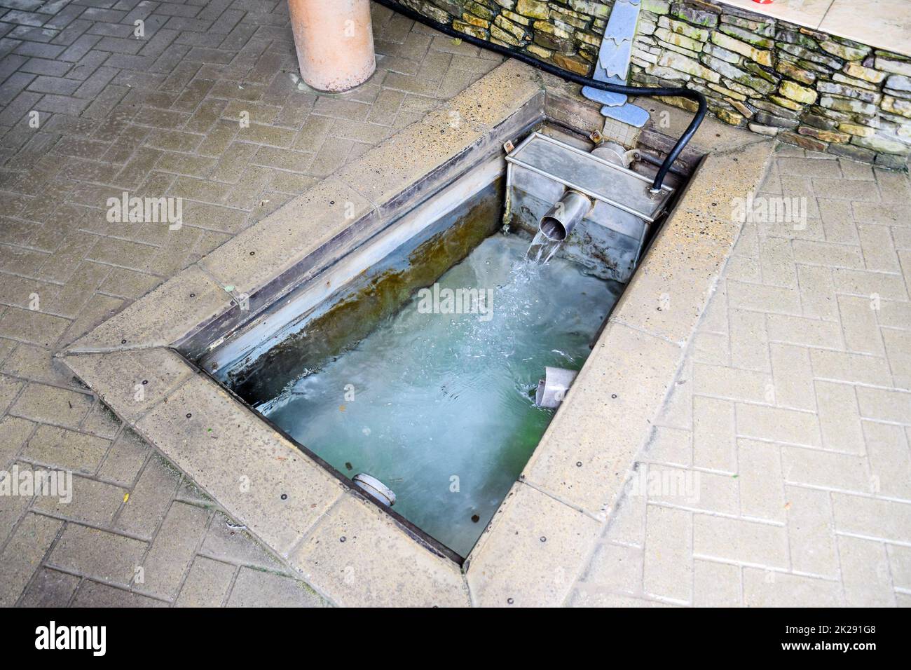 A small swimming pool with holy water from the spring. A niche in the floor for recruiting water from a source Stock Photo