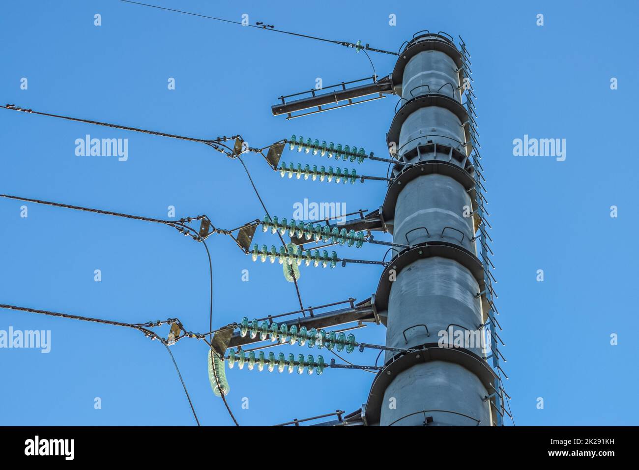 Supports high-voltage power lines against the blue sky Stock Photo