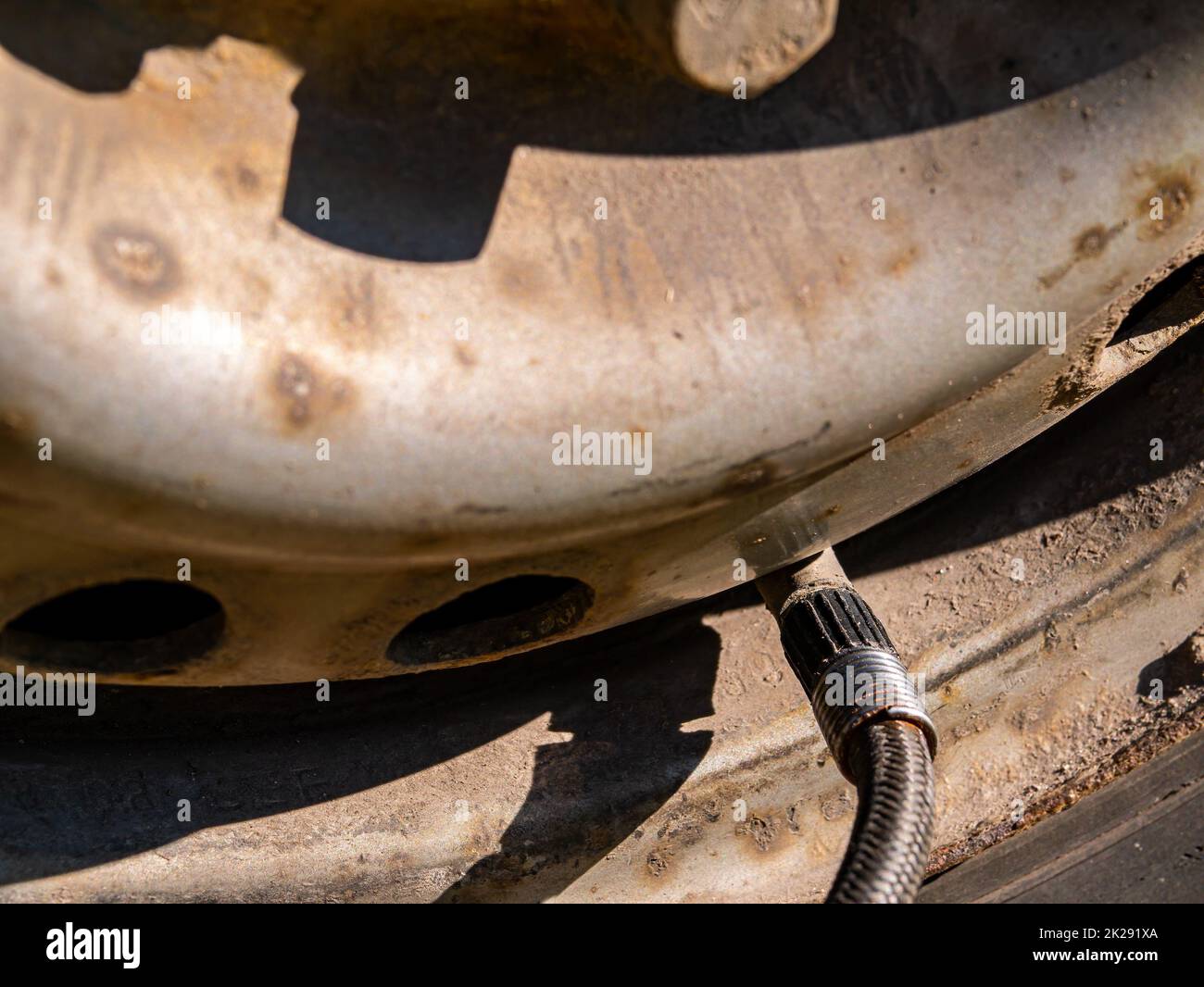 Inflating a car wheel tire in a tire service. Stock Photo