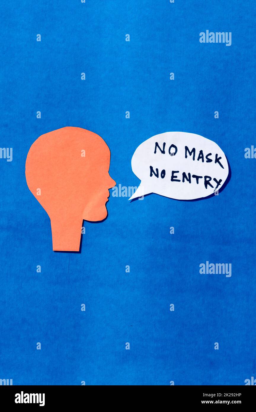 Paper Human face with No Mask No Entry sign on speech bubble isolated on blue background. Conceptual images showing that a person must accepts the conditions of wearing a mask before entering. Stock Photo