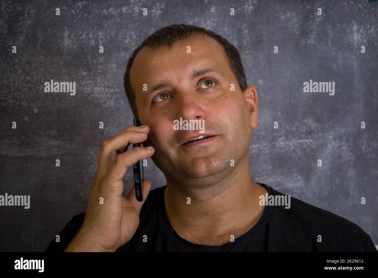 A young man is talking on the phone. Stock Photo