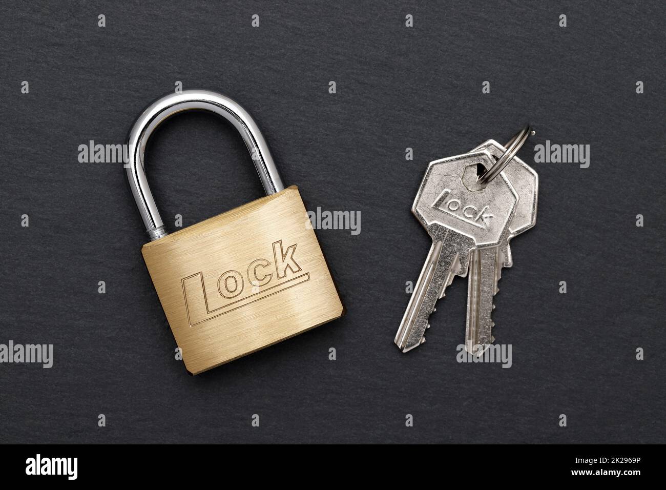 Steel padlock with key on a black background Stock Photo