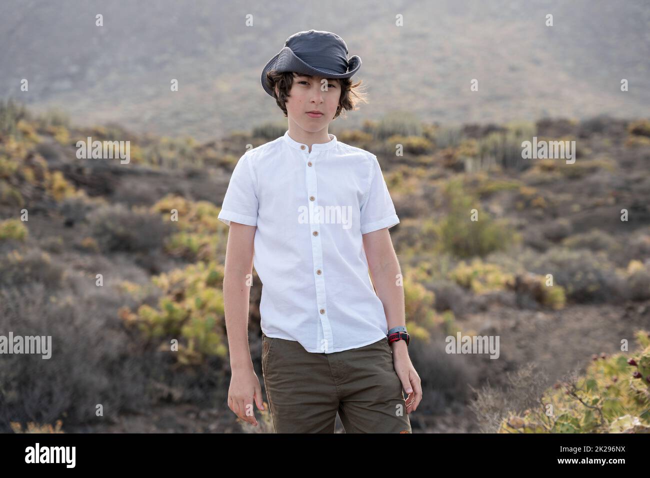 Portrait of a teenager against the backdrop of the Los Gigantes cliffs. View from cape Teno. Tenerife. Canary Islands. Spain. Stock Photo