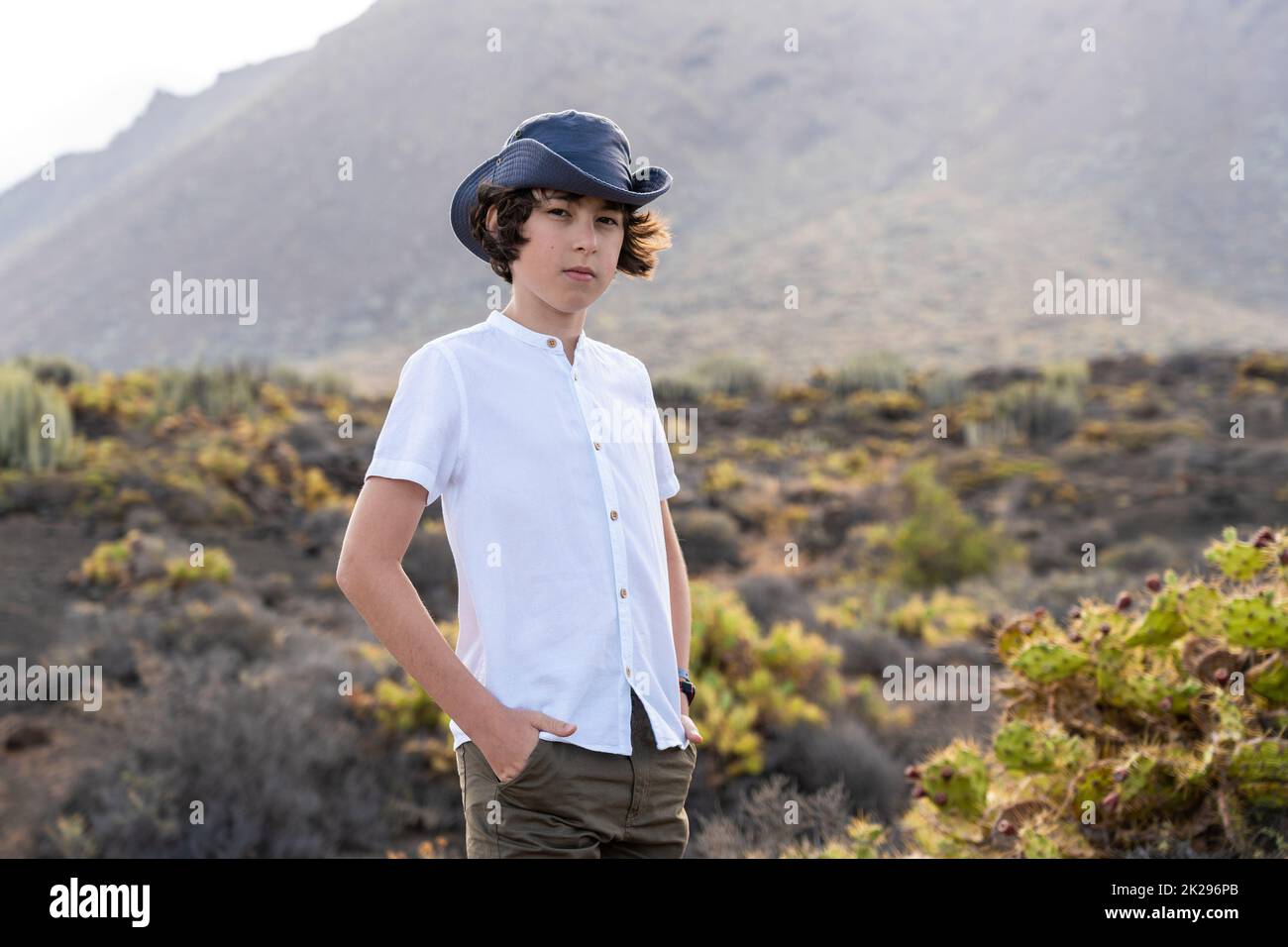 Portrait of a teenager against the backdrop of the Los Gigantes cliffs. View from cape Teno. Tenerife. Canary Islands. Spain. Stock Photo