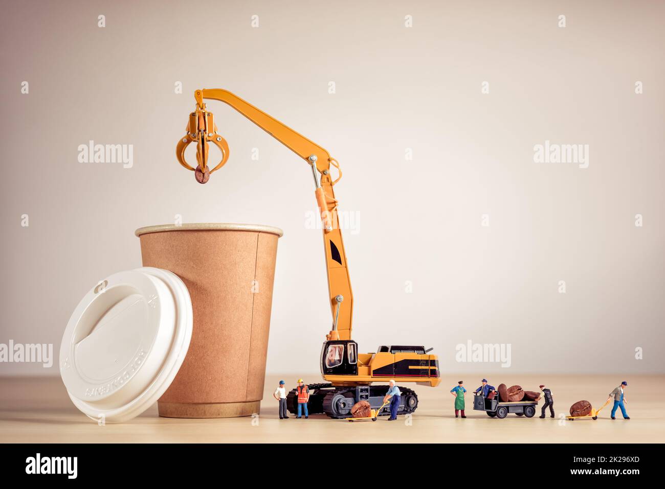 Miniature baristas making coffee in a to-go coffee cup Stock Photo