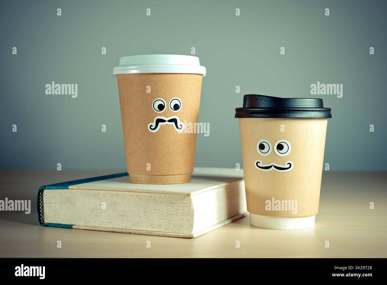 https://c8.alamy.com/comp/2K29728/two-cute-takeaway-coffee-cups-and-book-2K29728.jpg