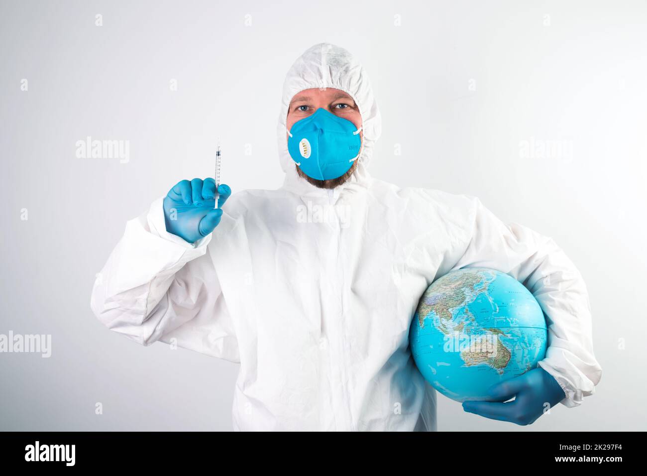 Doctor vaccinating the earth because of coronavirus Stock Photo