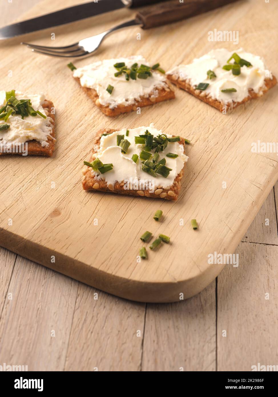 Sesame crackers with cream cheese and chives Stock Photo Alamy