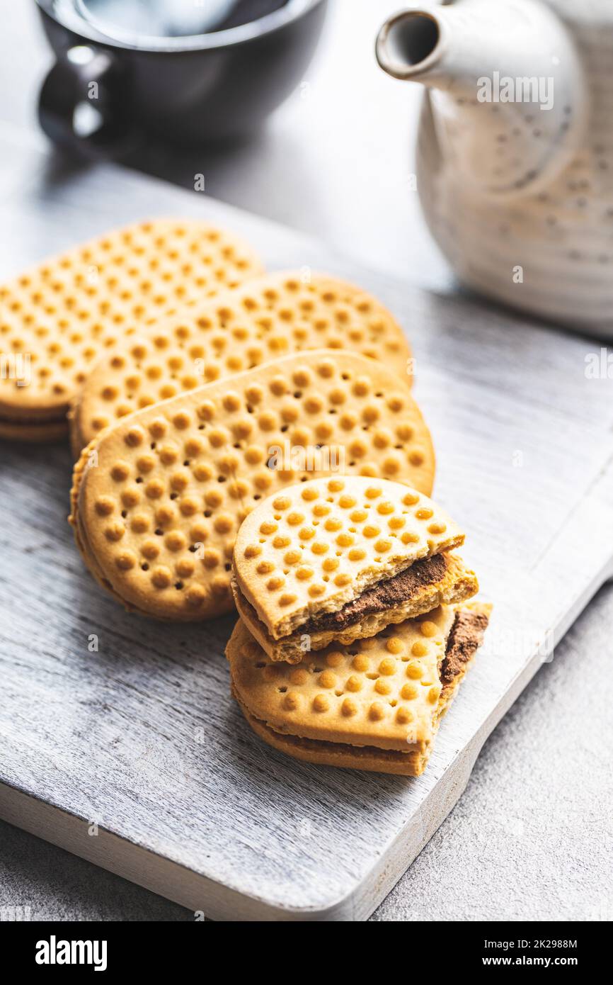 Sweet sandvich cookies. Biscuits with cocoa cream filling on white