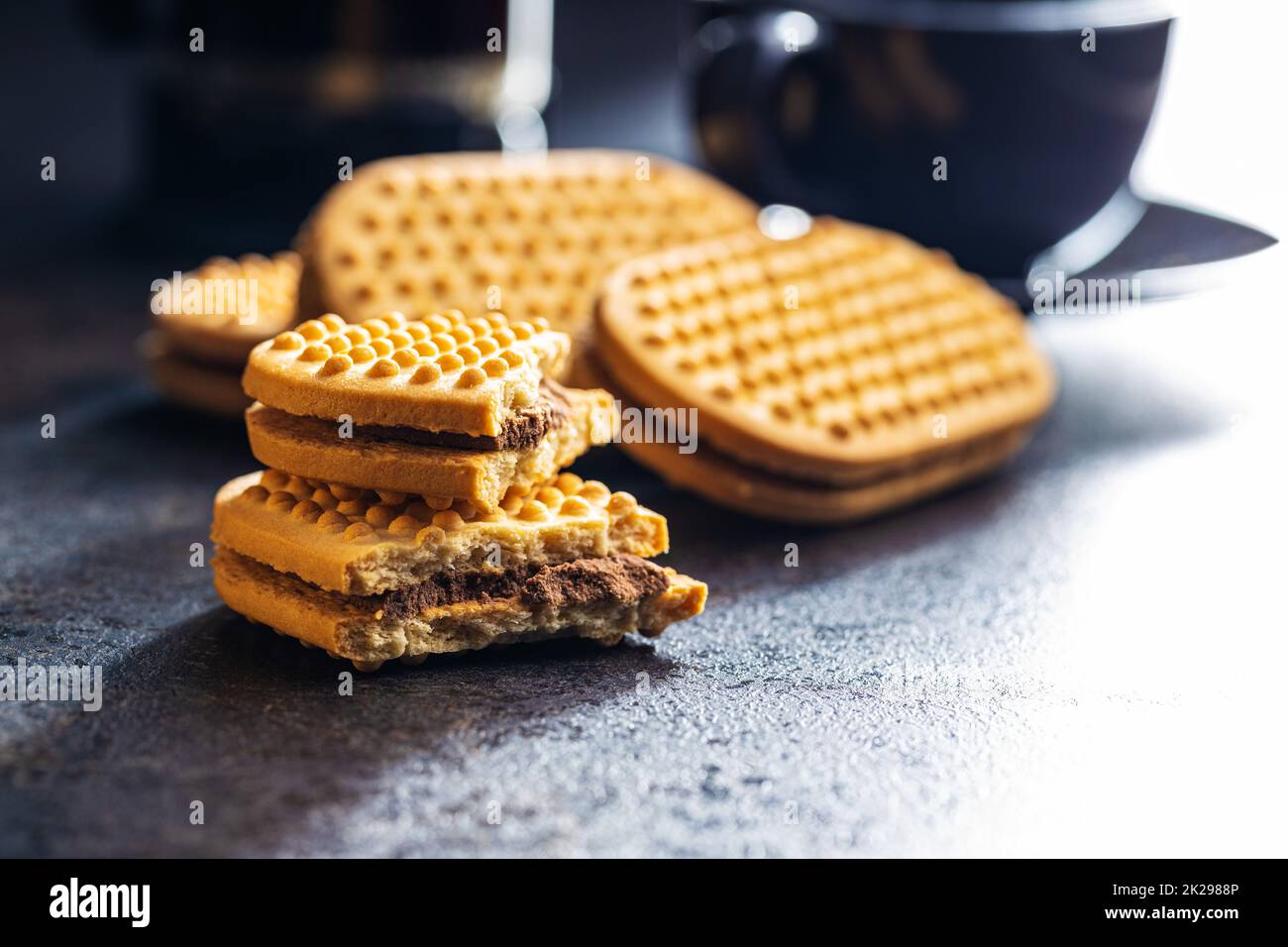 Sweet sandvich cookies. Biscuits with cocoa cream filling on kitchen table. Stock Photo