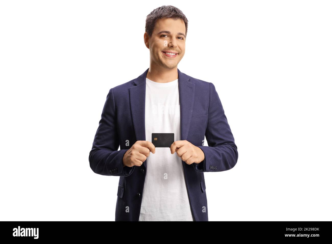 Smiling young man holding a credit card isolated on white background Stock Photo
