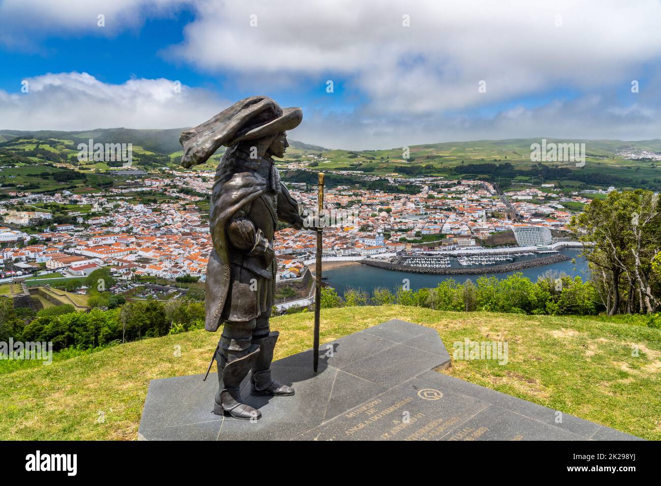 Statue of Afonso VI Second King of Portugal on Monte Brasil with a view of the historic city centre, public beach called the Praia de Angra do Heroismo below, in Angra do Heroismo, Terceira Island, Azores, Portugal. Stock Photo