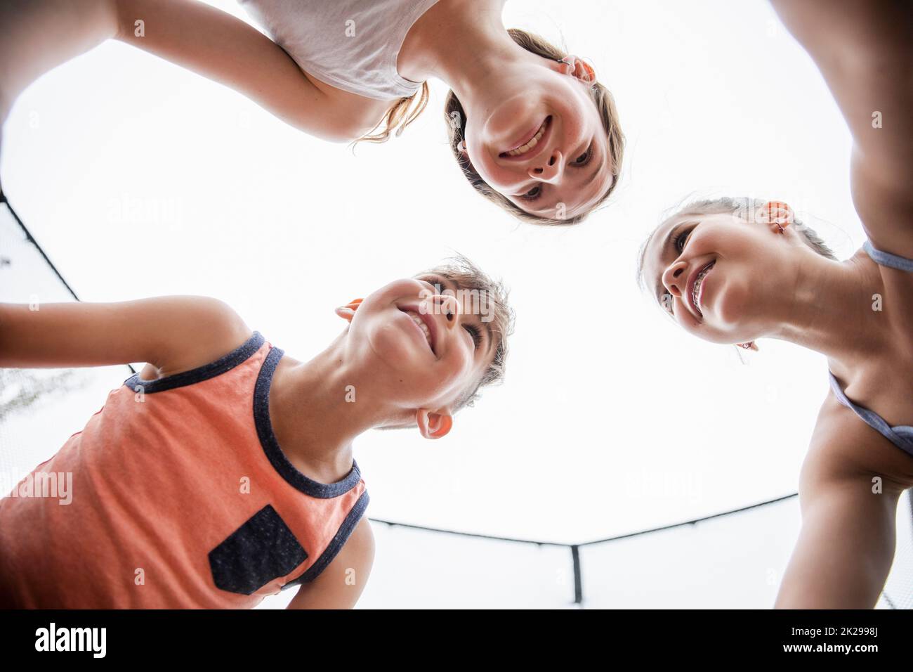 View from below of girls and boy huddling Stock Photo