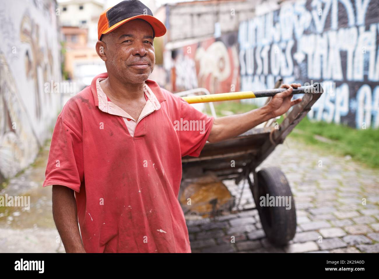 I keep this city clean. Portrait of a garbage collector with his cart in the streets of Brazil. Stock Photo