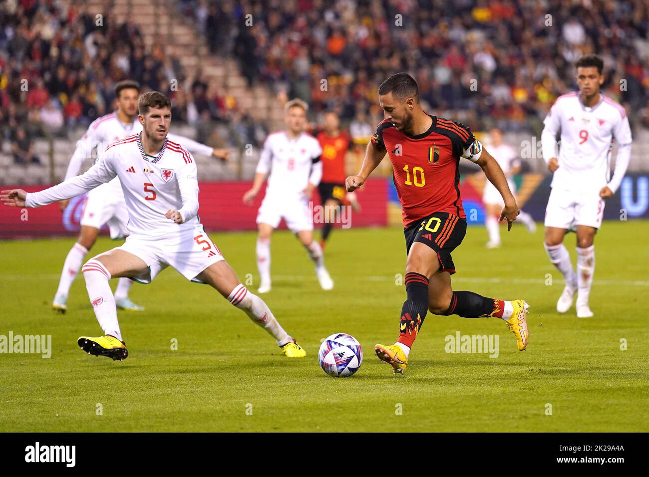 Belgium's Eden Hazard and Wales' Chris Mepham (left) battle for the ball during the UEFA Nations League Group D Match at King Baudouin Stadium, Brussels. Picture date: Thursday September 22, 2022. Stock Photo