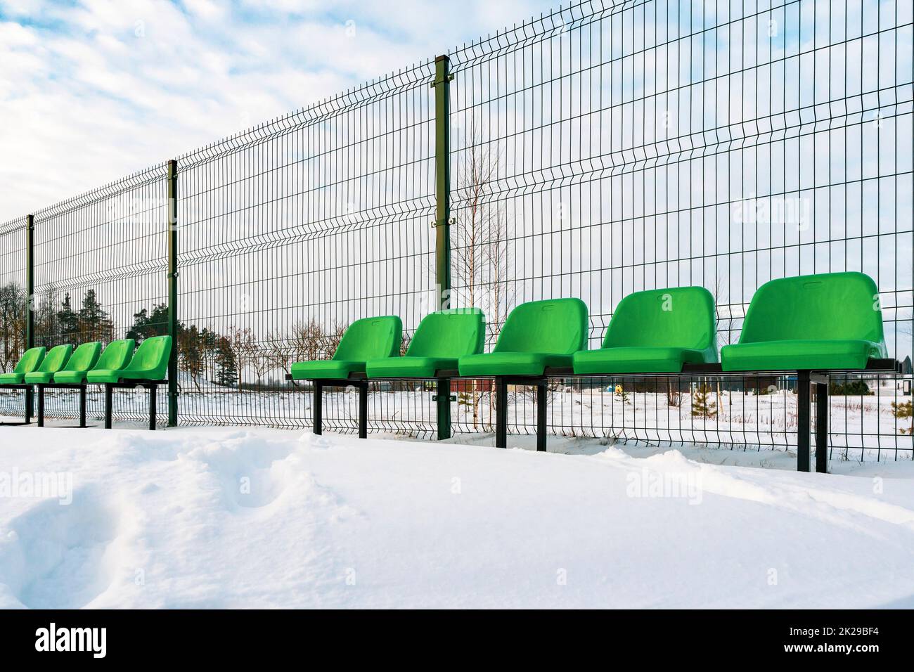The row of plastic green seats at sports stadium Stock Photo