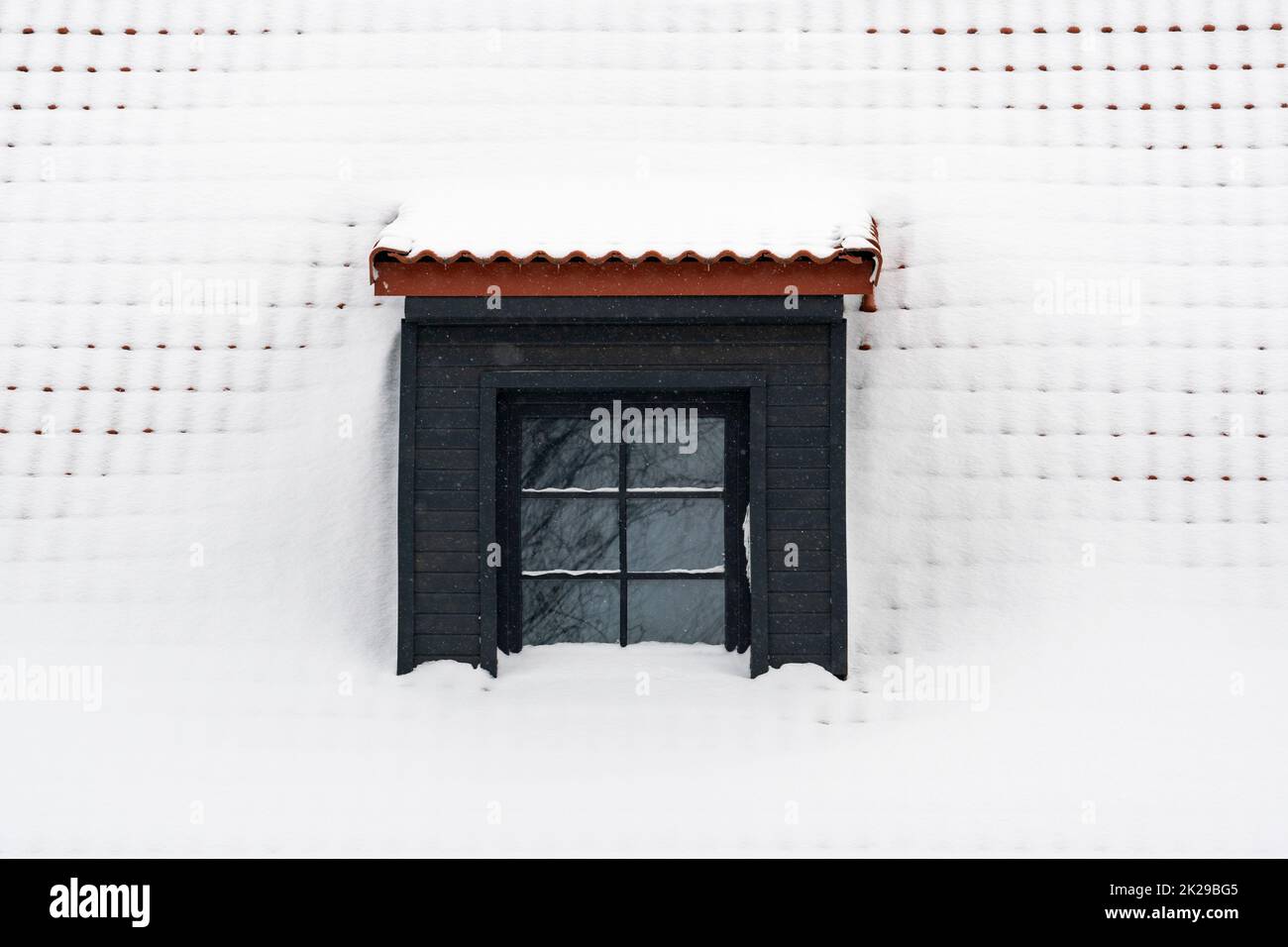 Dormer on a roof under fresh snow Stock Photo