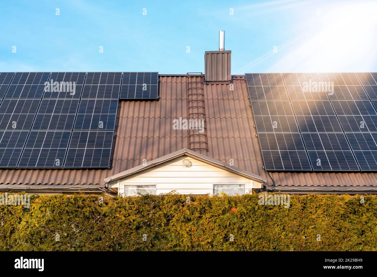 House roof with a solar panels on top Stock Photo