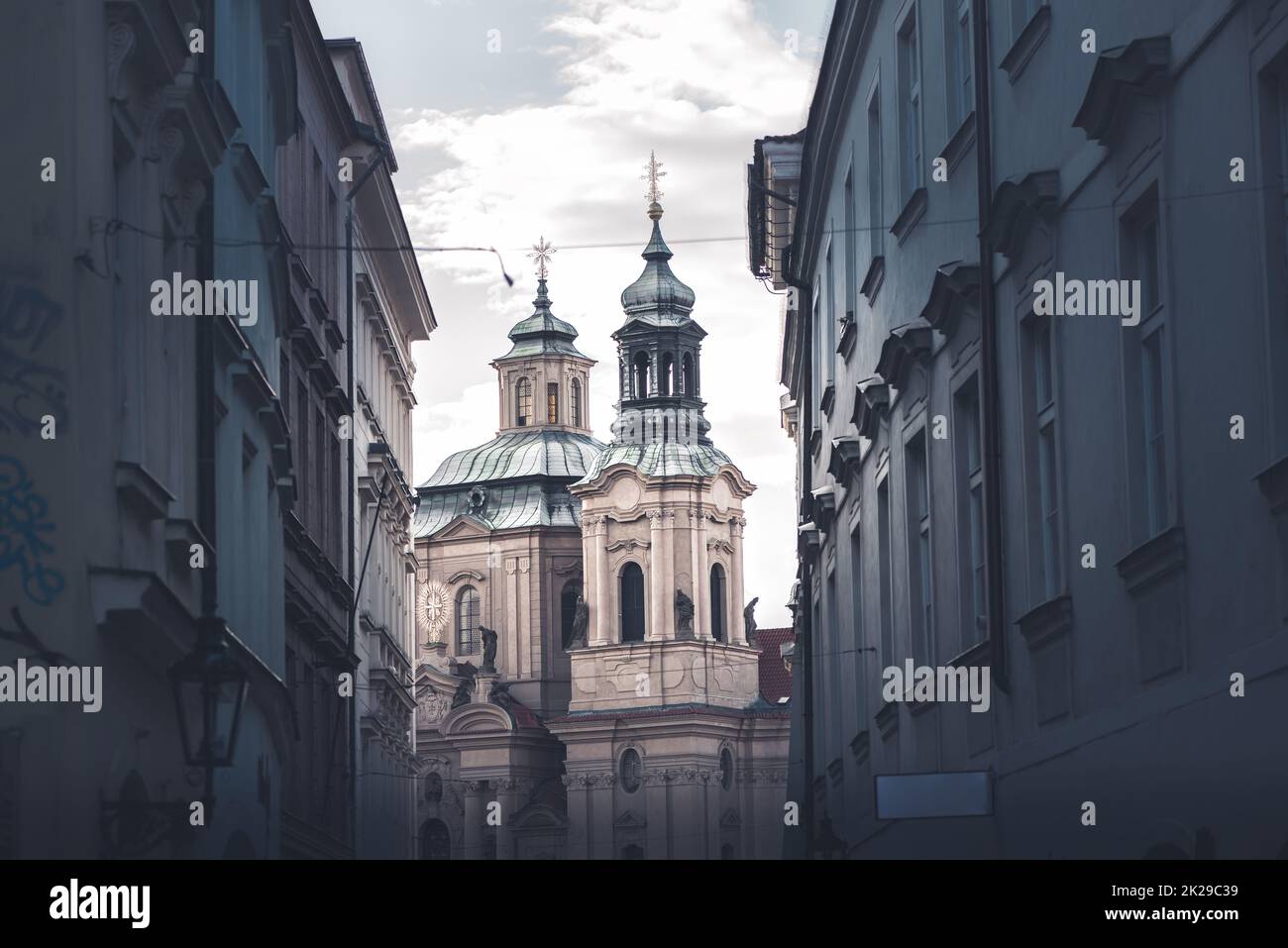 St. Nicholas Church seen through street. Stare Mesto, Prague, Czech Republic Stock Photo