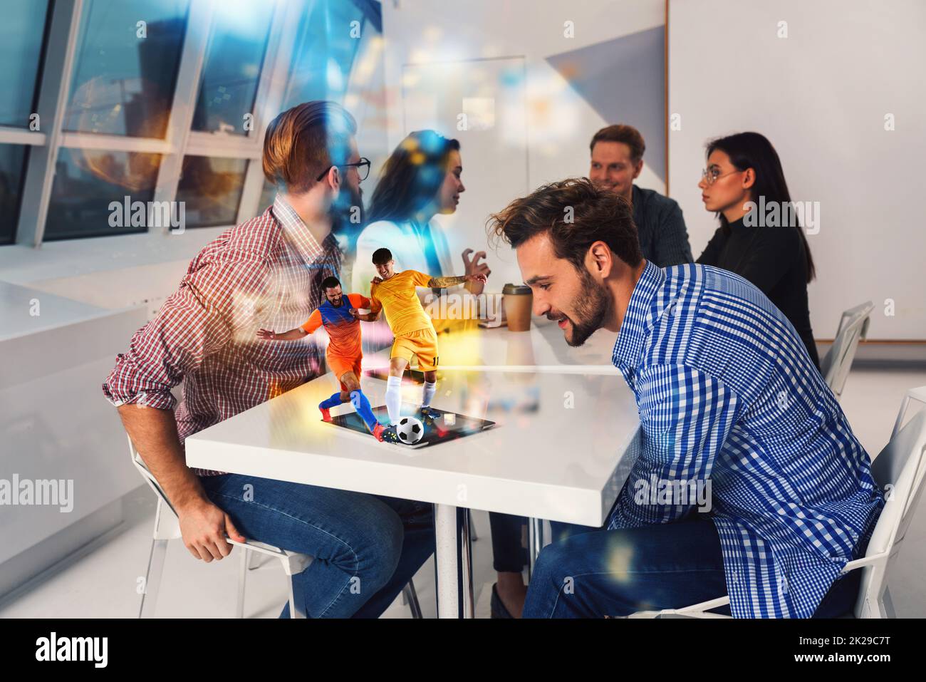 Friends watch a soccer match via streaming service Stock Photo