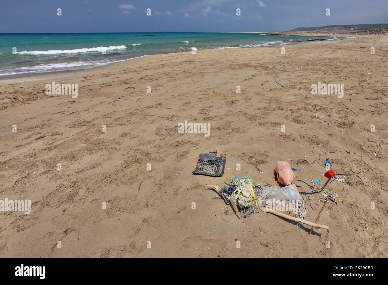 Beautiful empty wild beach in Karpass, Cyprus, with rubbish on the sand. Ocean littering concept. Stock Photo