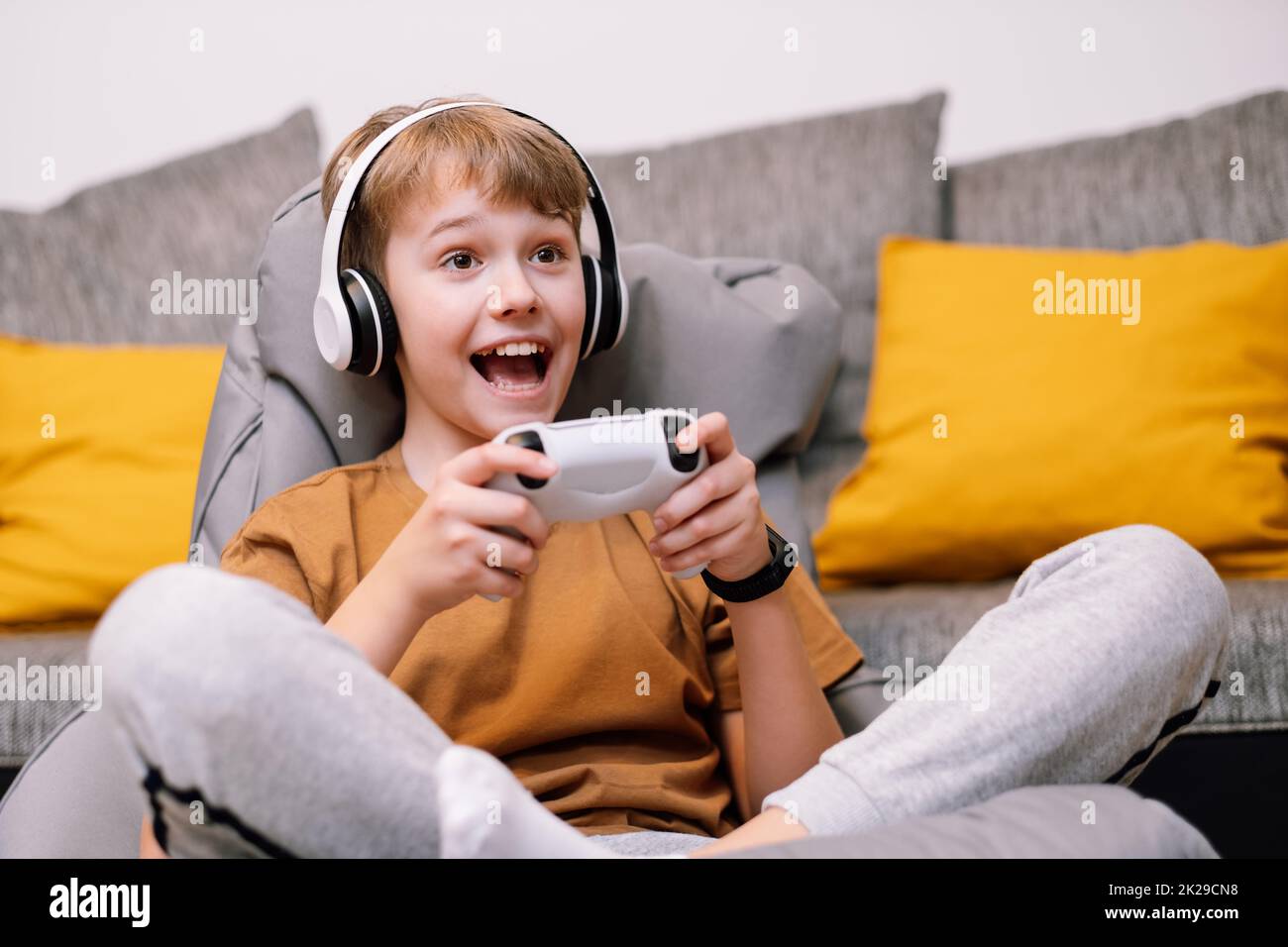 Having Fun at Home. Cheerful Black Teen Guy with Joystick Playing Online  Computer Games, Sitting on Couch Indoors Stock Image - Image of computer,  person: 227478857