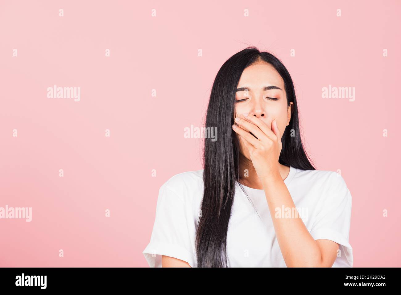 woman emotions tired and sleepy her yawning covering mouth open by hand Stock Photo