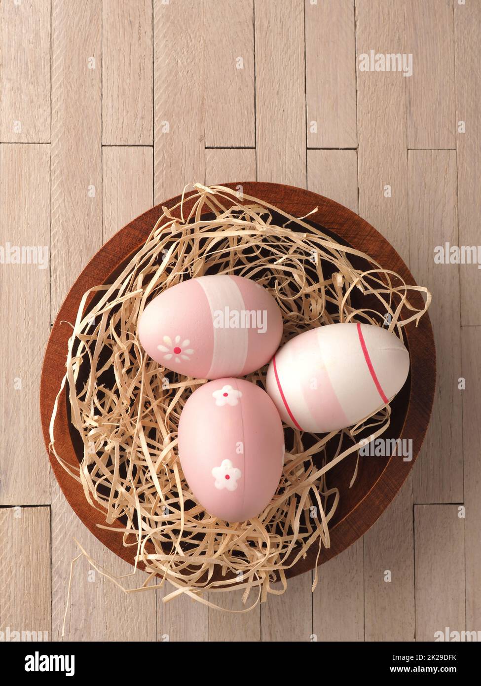 Three pink Easter eggs in a nest Stock Photo