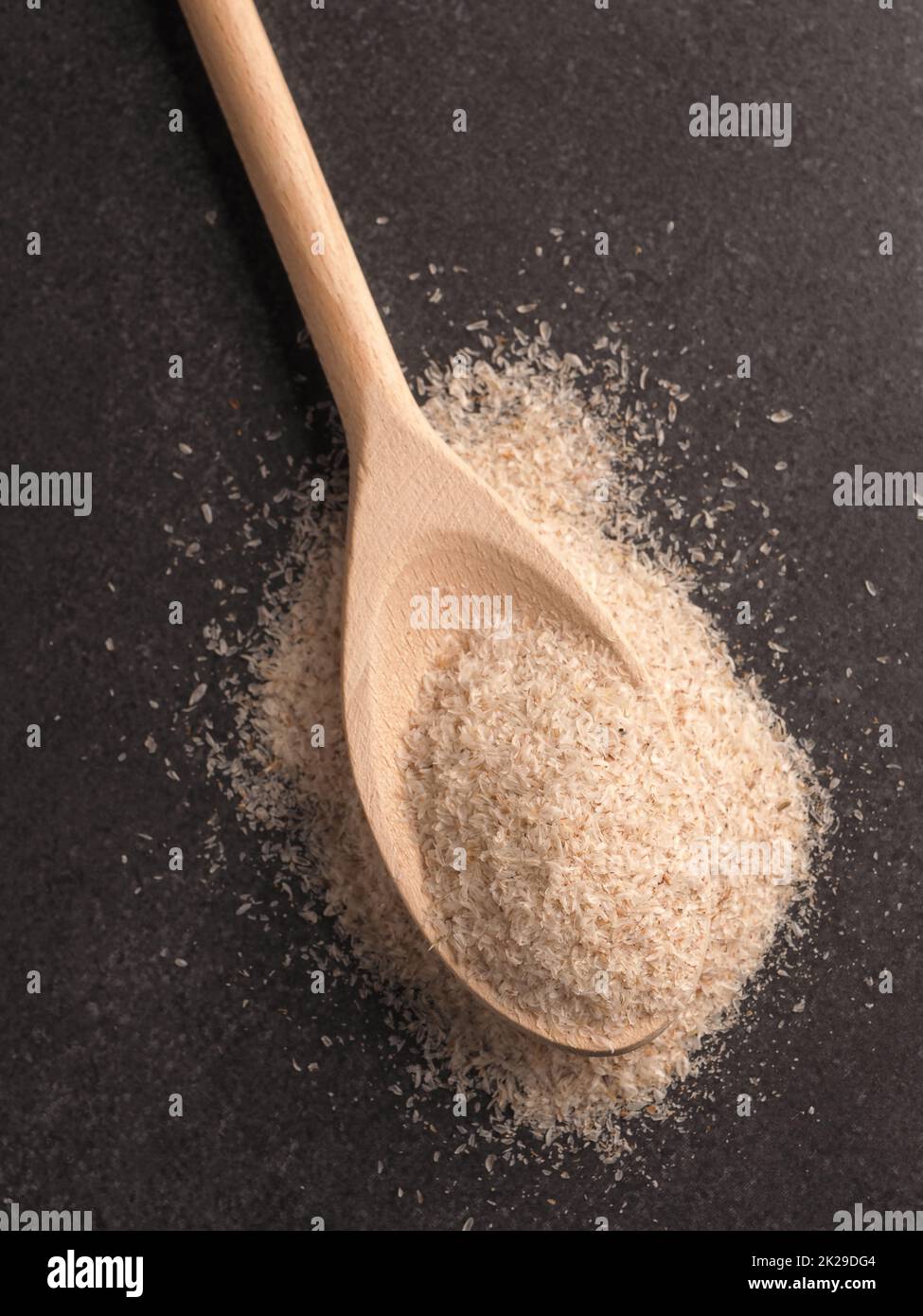 Husjs Psyllium husks on a wooden spoon Stock Photo - Alamy