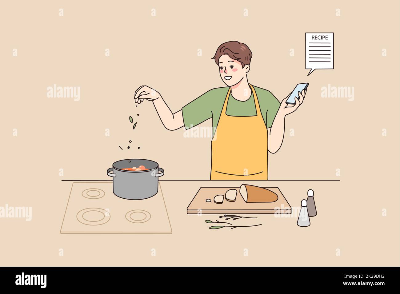 Smiling man cooking with recipe on cellphone Stock Photo