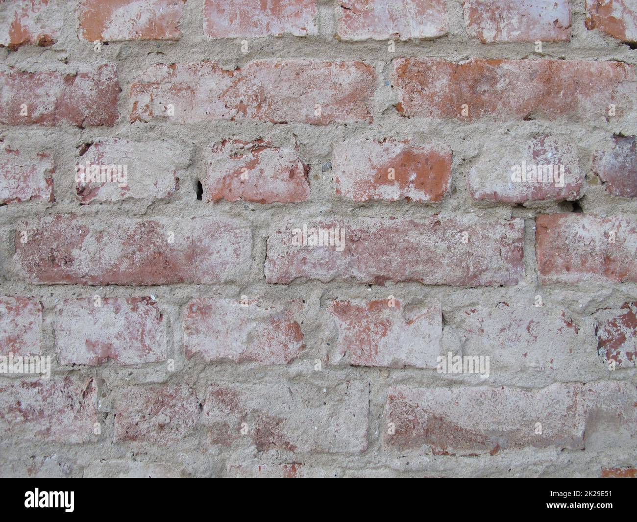 Brick masonry freed from plaster, unplastered house brick wall without wall plastering Stock Photo