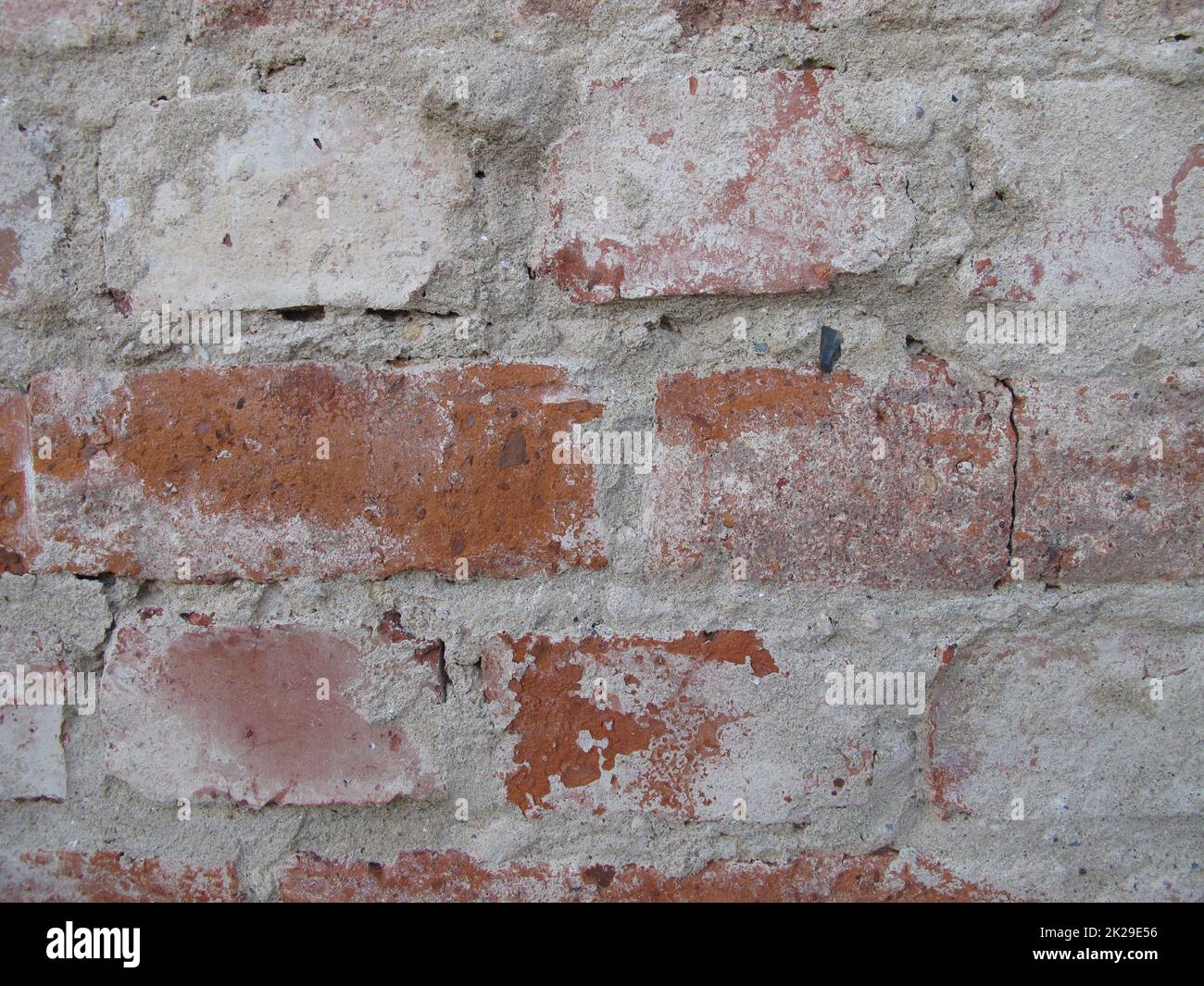 Brick masonry freed from plaster, unplastered house brick wall without wall plastering Stock Photo