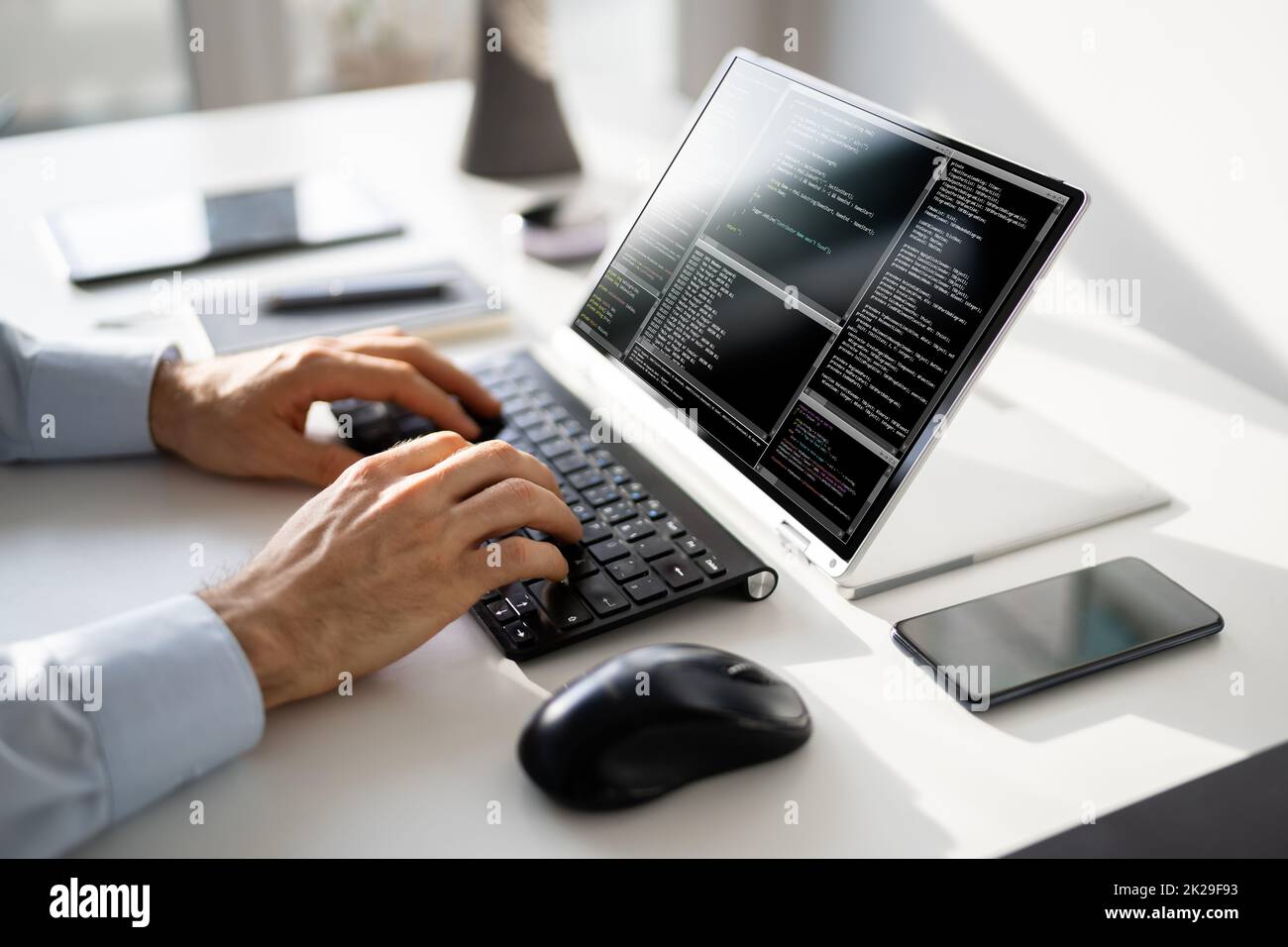 Computer Programmer Writing Program Code On Computer Stock Photo