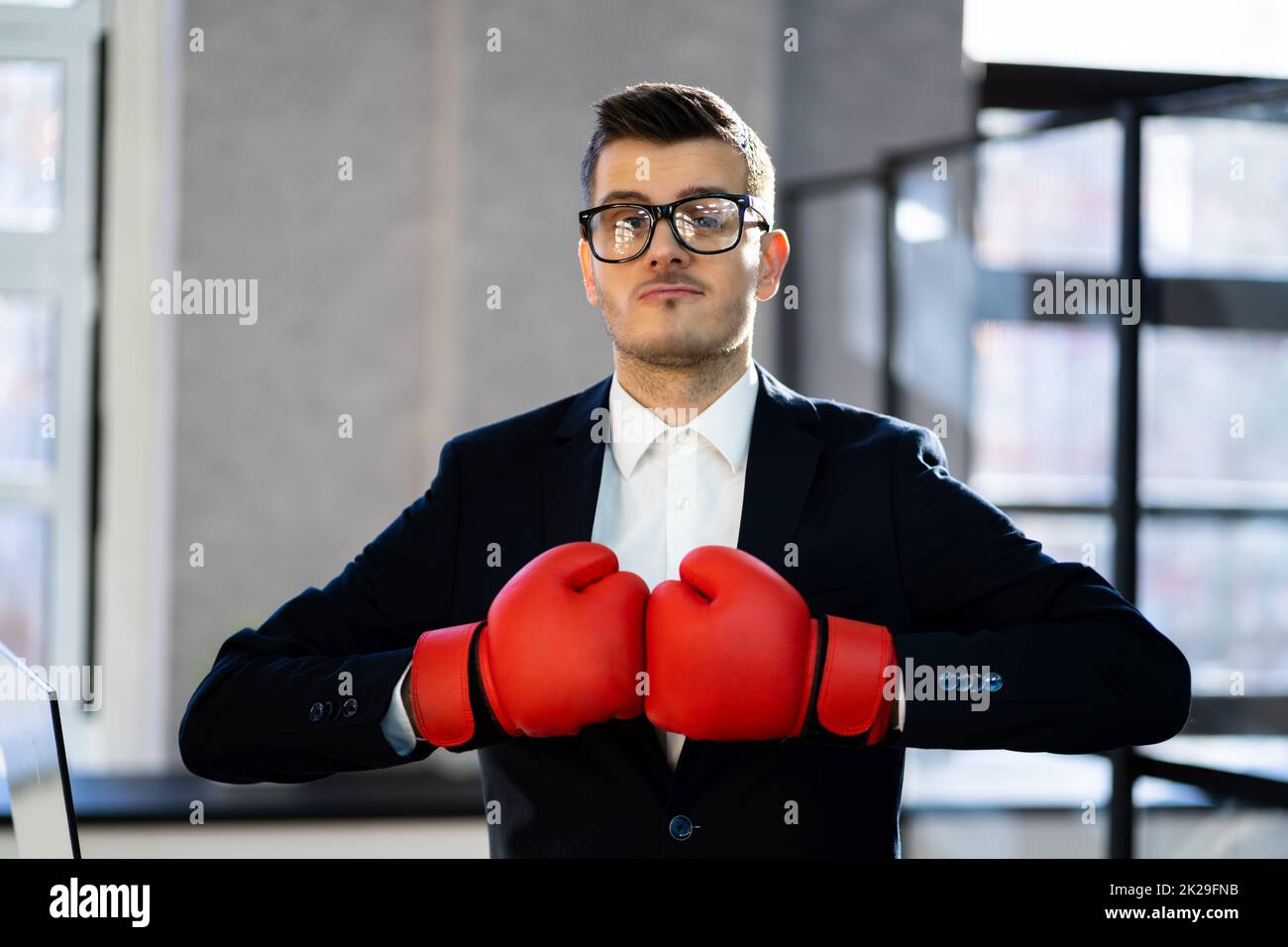 Midsection Of Businessman Wearing Boxing Gloves Stock Photo