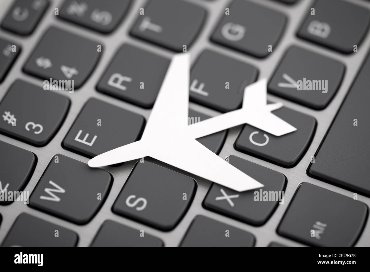 Paper airplane shape on computer keyboard Stock Photo Alamy