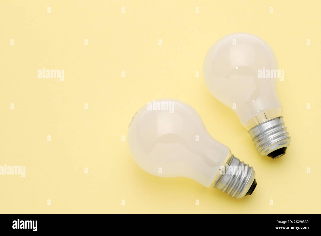 previously used the light bulb on yellow background Stock Photo