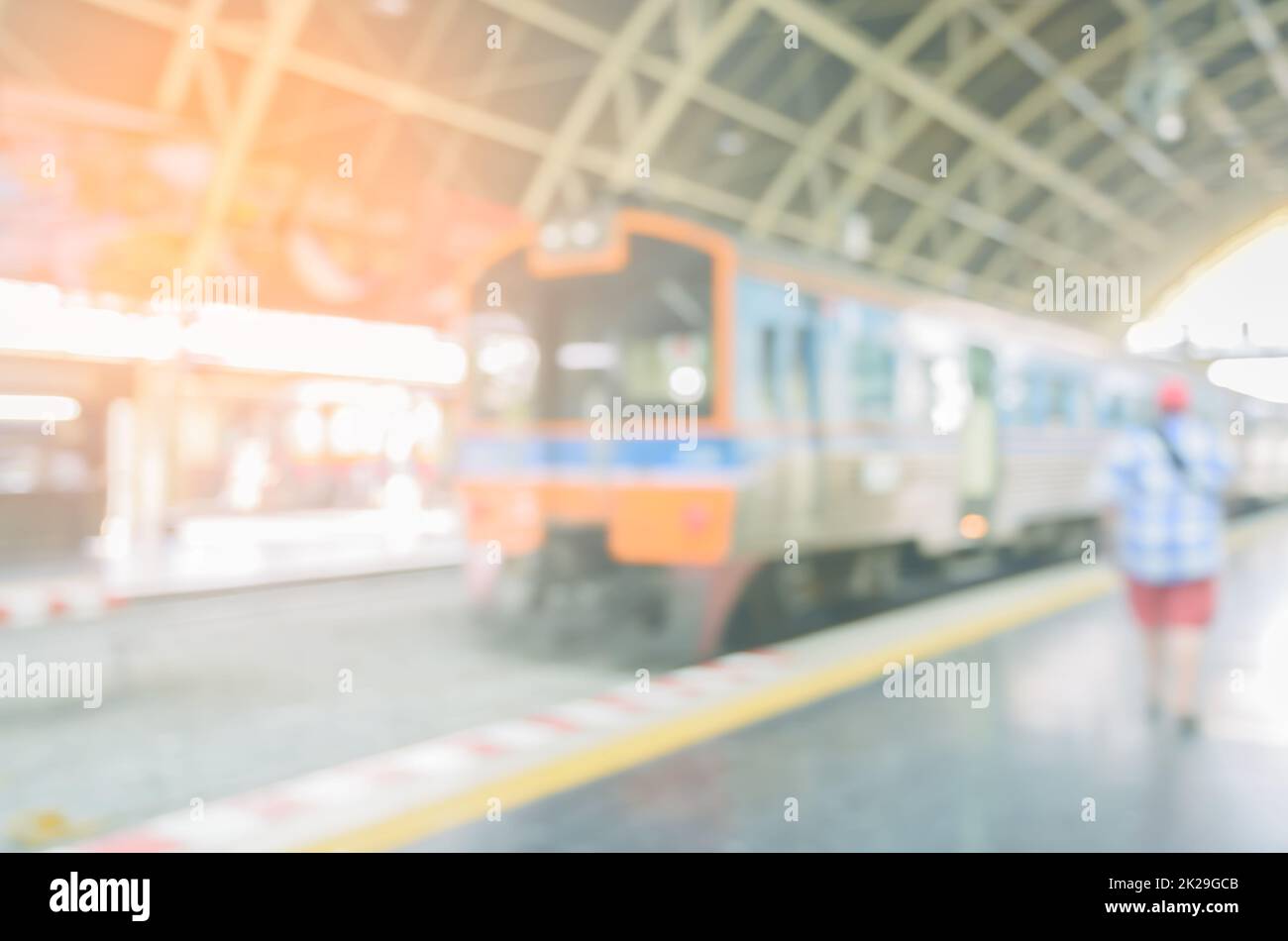 Railway platform with passenger train. Blurred train on railroad track