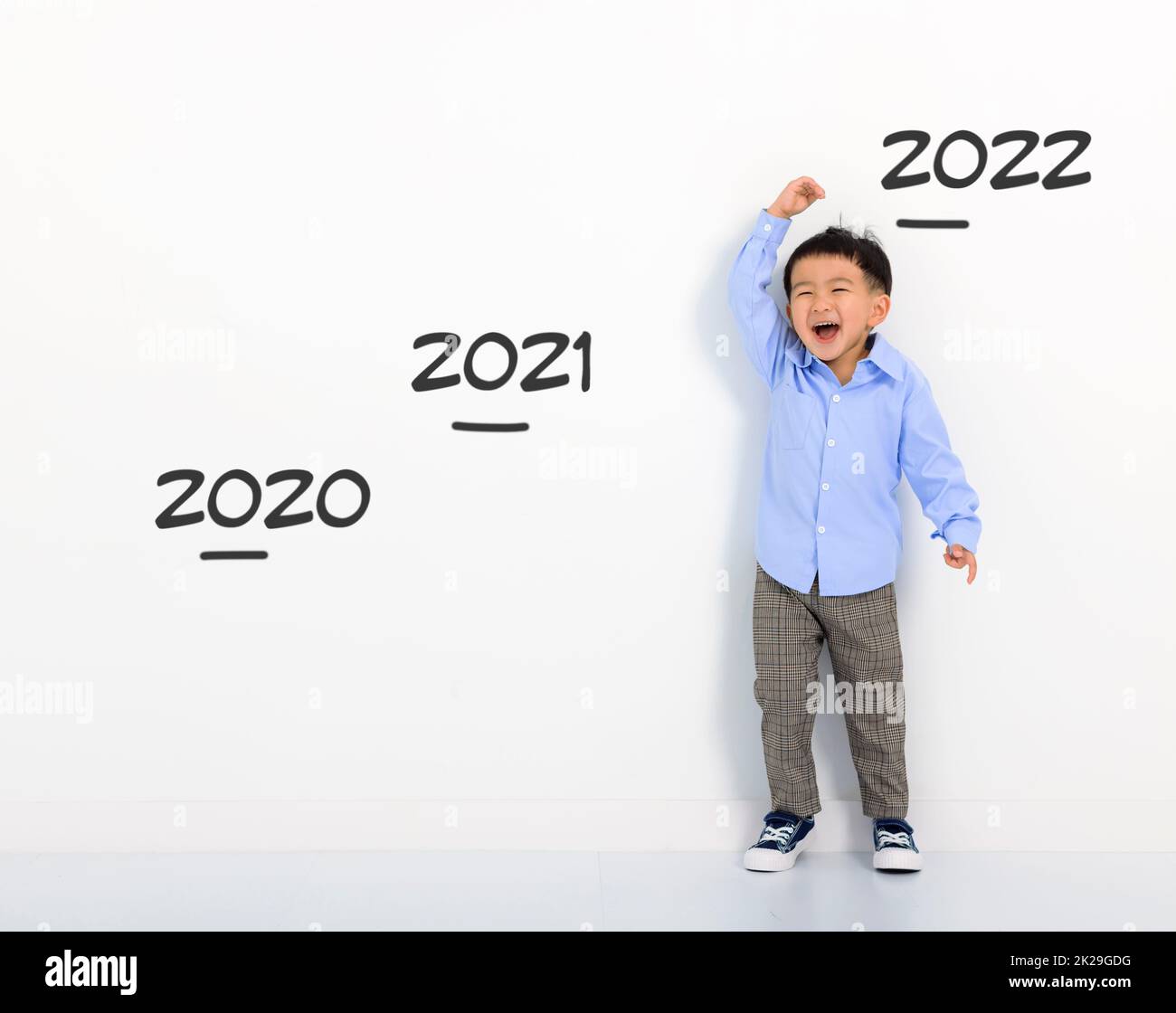 Happy Little boy measuring height at home Stock Photo