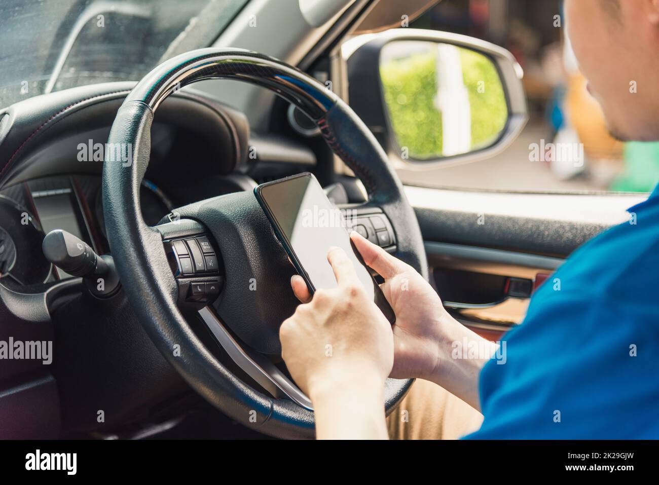 delivery man courier online holding deliveries out boxes inside the car