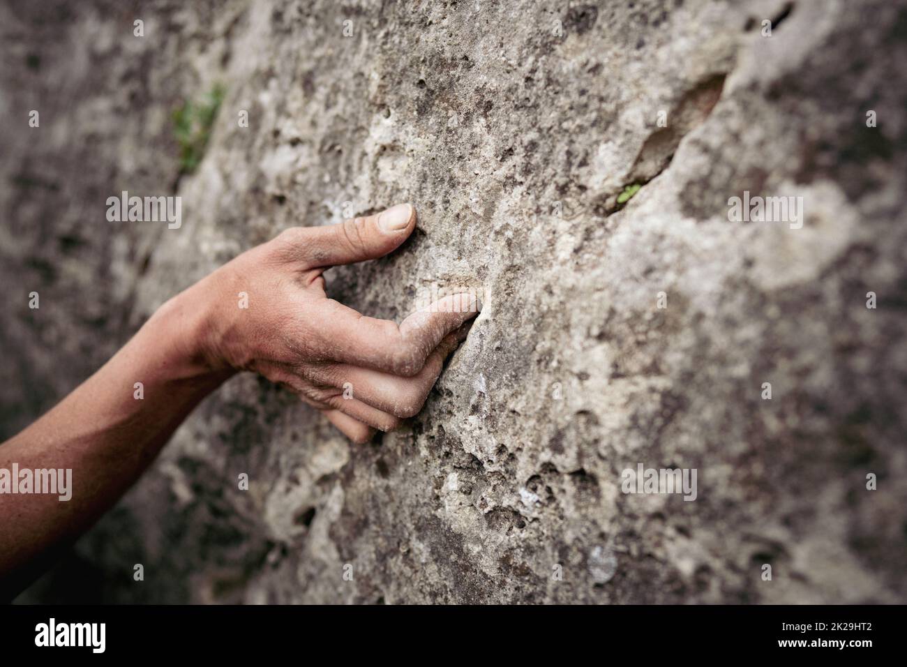 Close up shot of an adult male handholding on to a rock, illustration ...