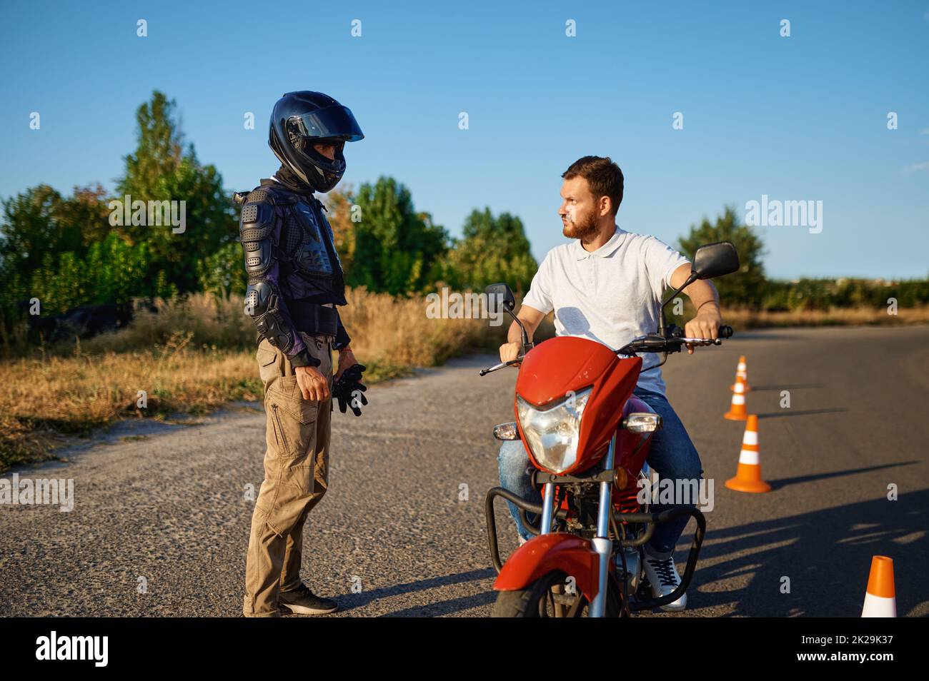 Male student and instructor, lesson on motordrome Stock Photo