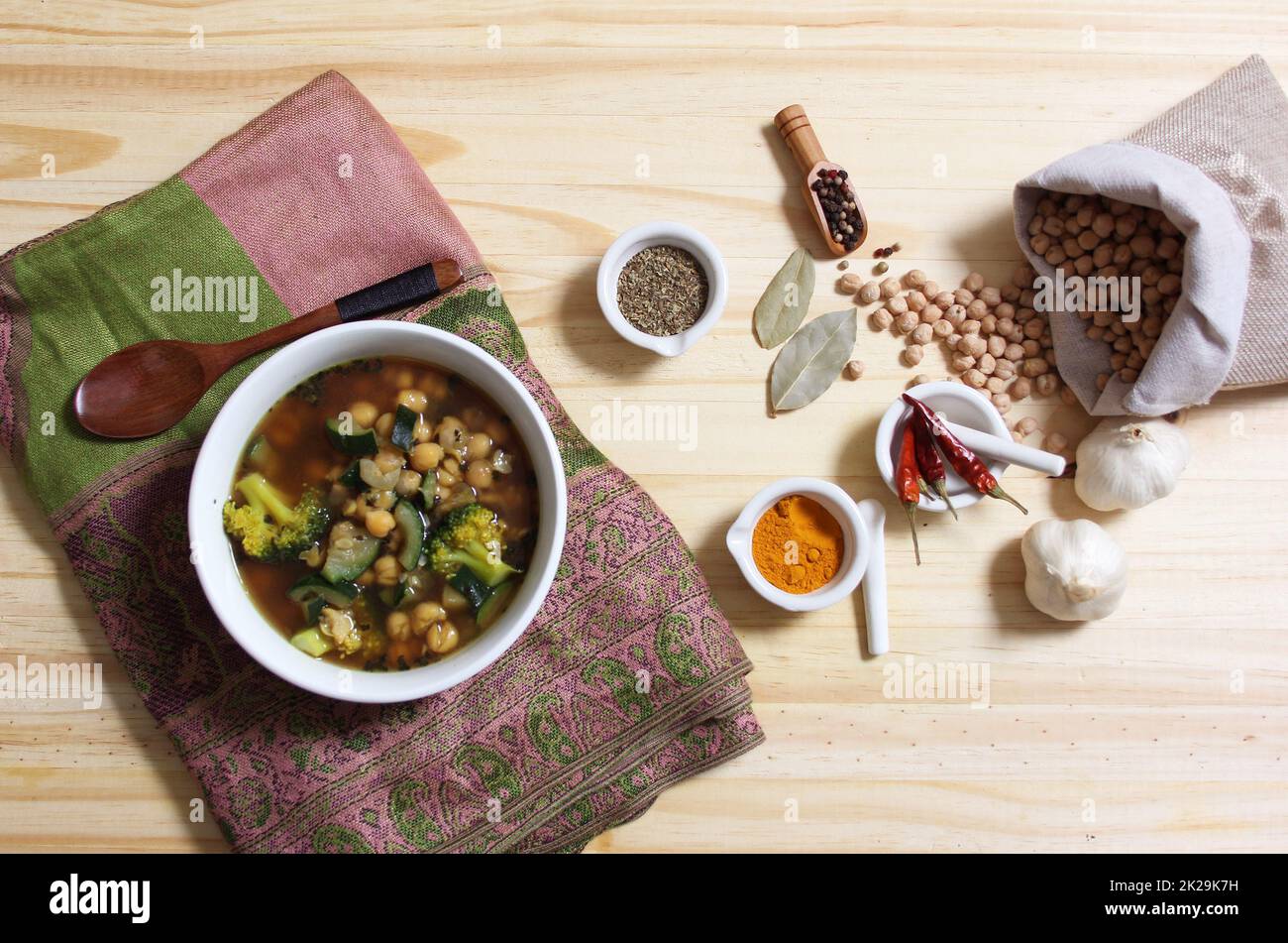 Garbanzo Beans With Zucchini and Broccoli With Spices on Rustic Table