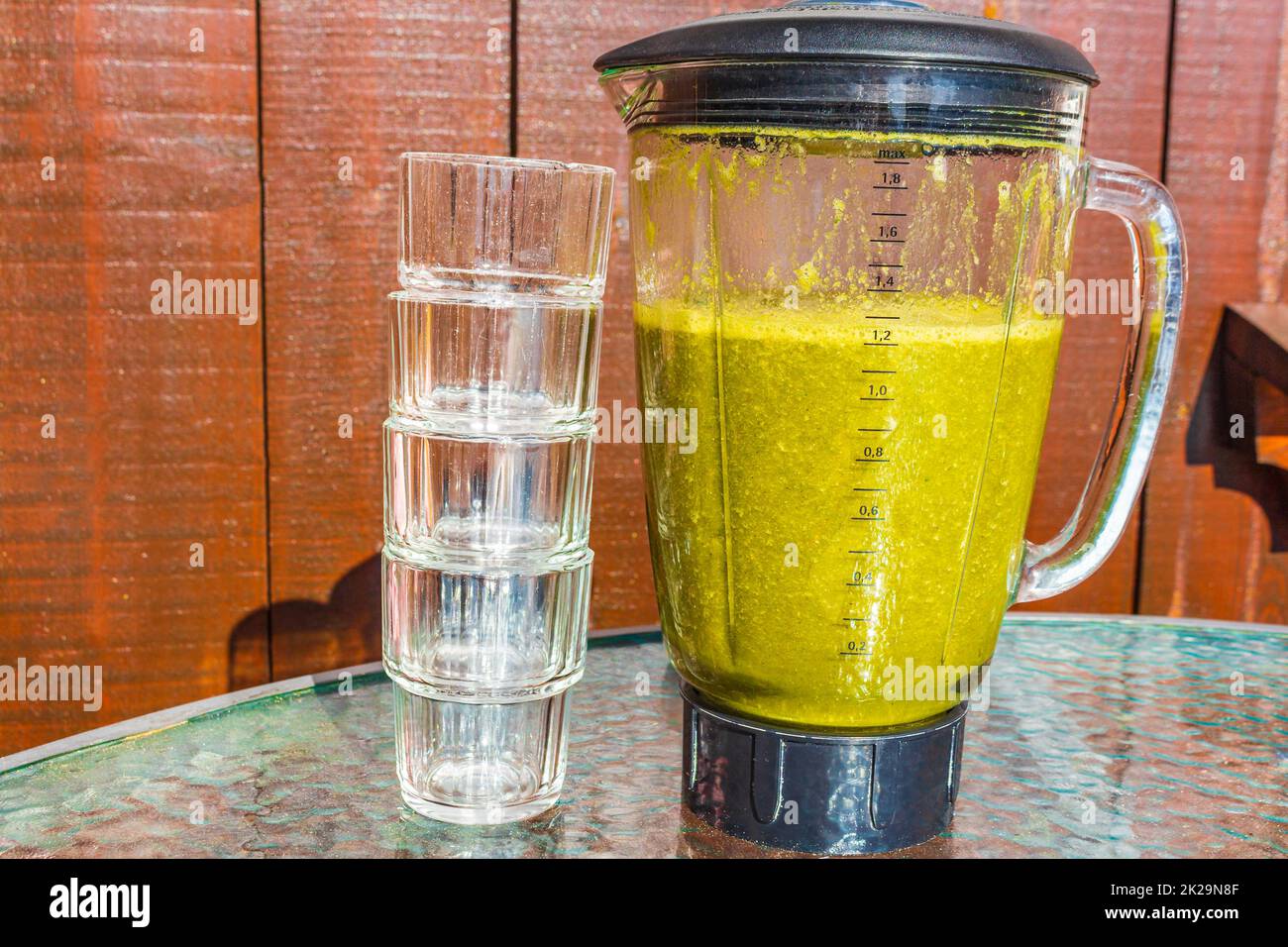 Green healthy smoothie with vegetable fruit salad greens in Blender