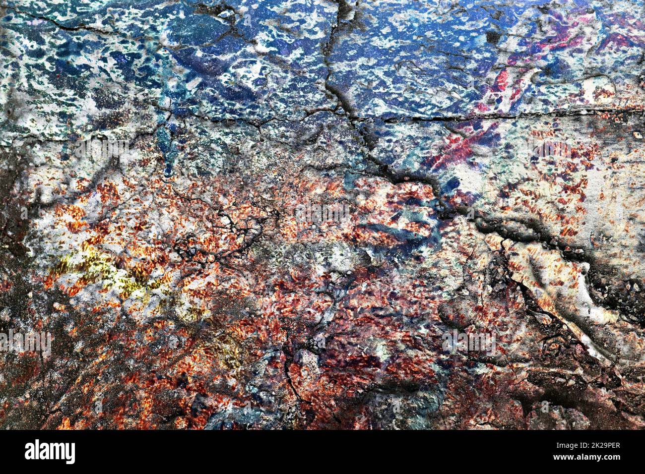 Texture of colorful graffiti paint on conrete and brick walls in red blue purple and silver Stock Photo