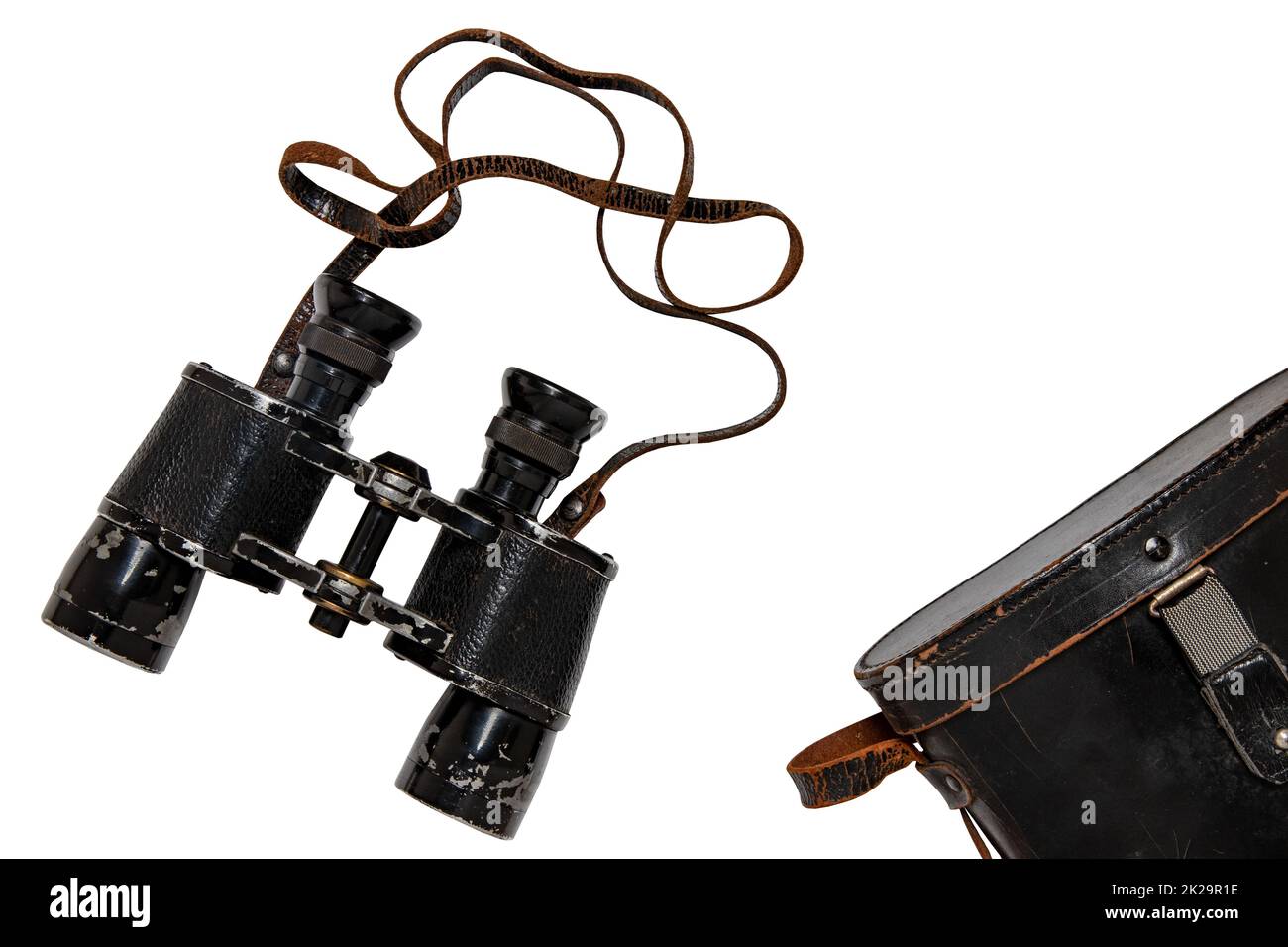 Vintage binoculars isolated. Closeup of vintage German binoculars with leather case used by the