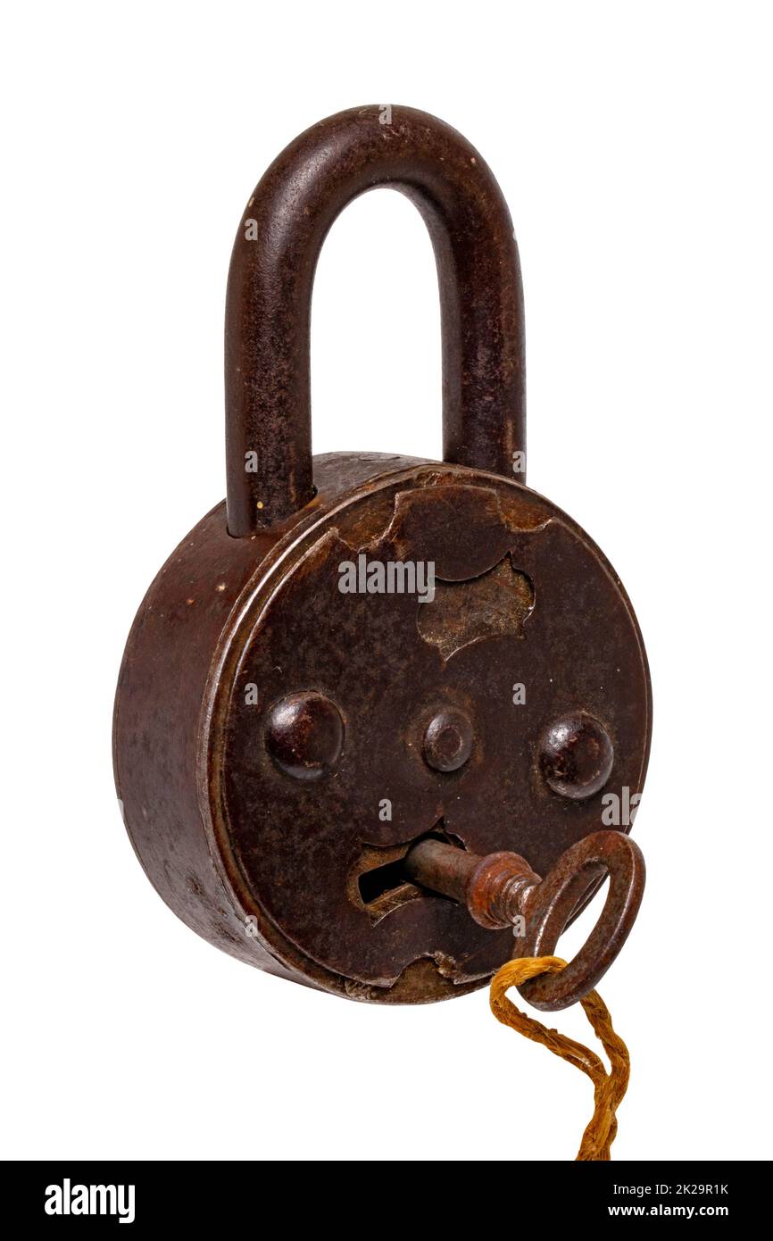 Vintage padlocks isolated. Close-up of a ancient big padlock with key isolated on a white background. Antique objects with clipping path. Macro photograph. Stock Photo